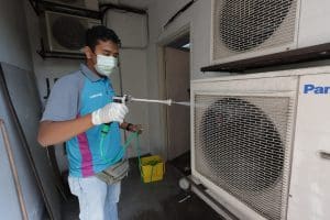 Cleaning outdoor aircon compressor office balcony